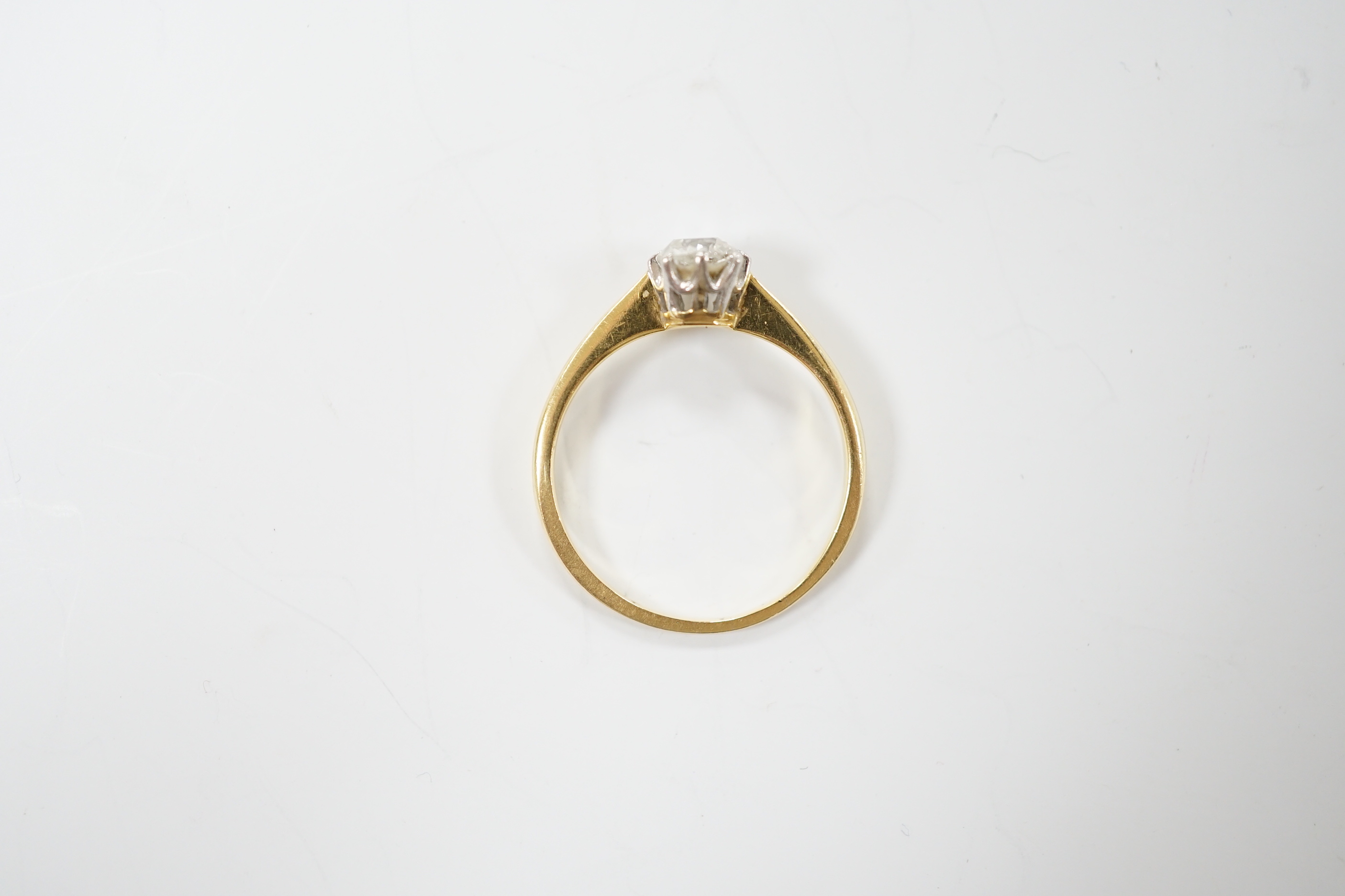 A yellow metal and solitaire diamond ring, stone diameter 5.1mm, size L, gross weight 1.8 grams.